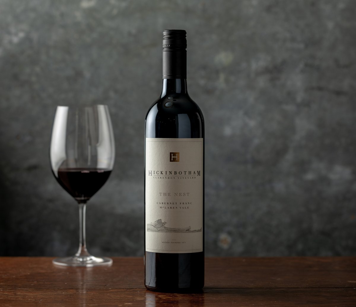 The Nest Bottle and wine glass on table