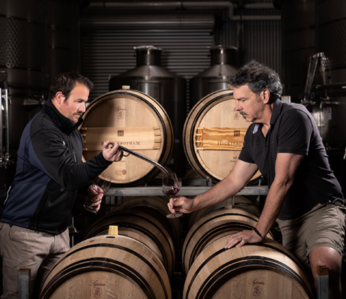 Winemakers with a wine thief